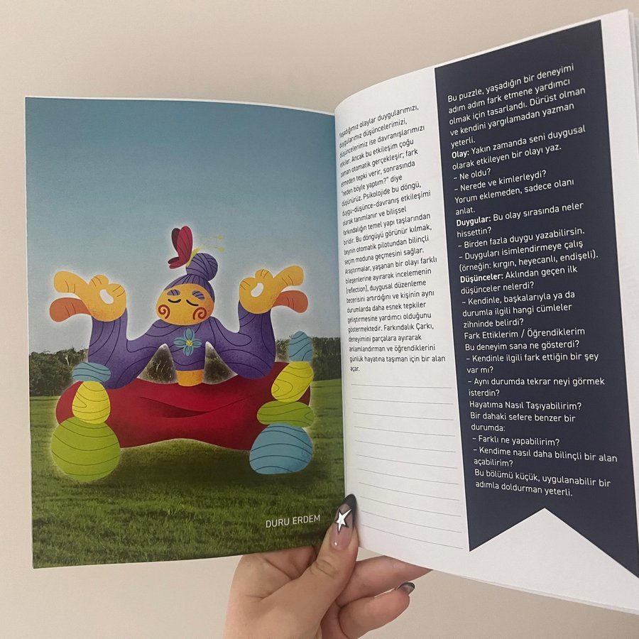Photo of the illustration printed in a charity booklet, held open by hand