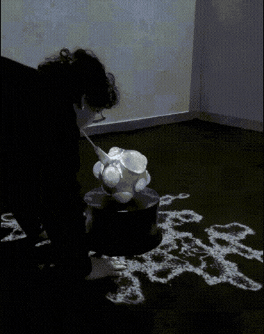 Visitor interacting with Nexus as projections respond on the walls