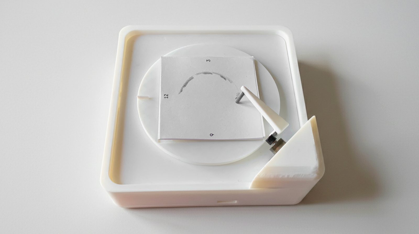 Synchribble device — a white desktop object with a rotating disc and stylus arm