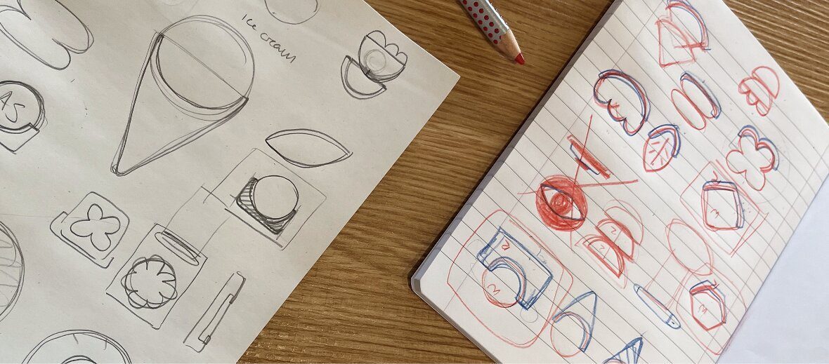 Early ideation sketches exploring pin shapes and concepts